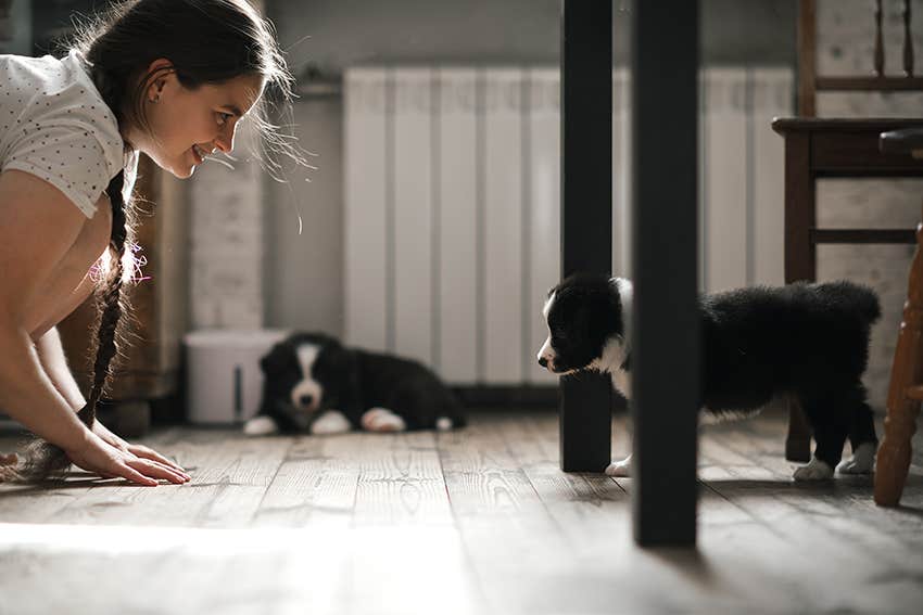 woman baby-talks to a puppy