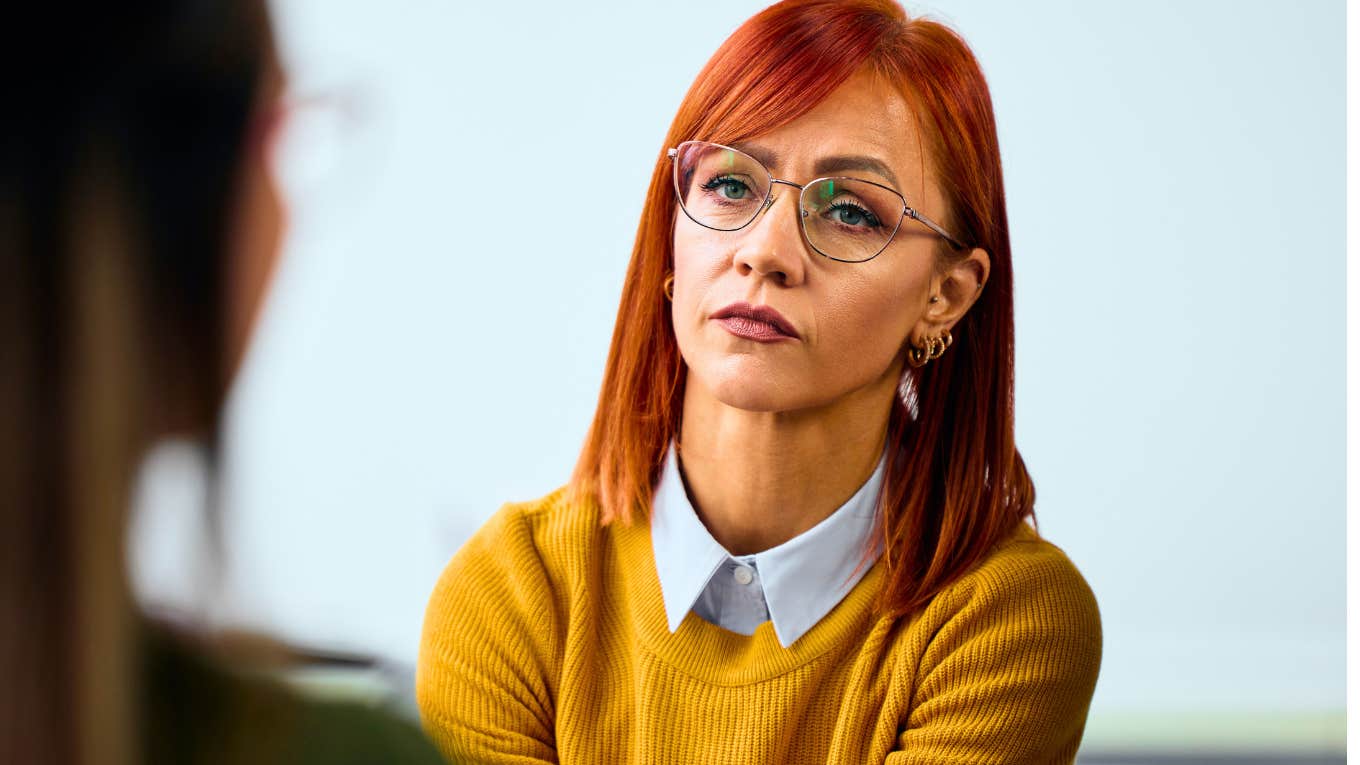 quiet woman listening intently to her friend speak