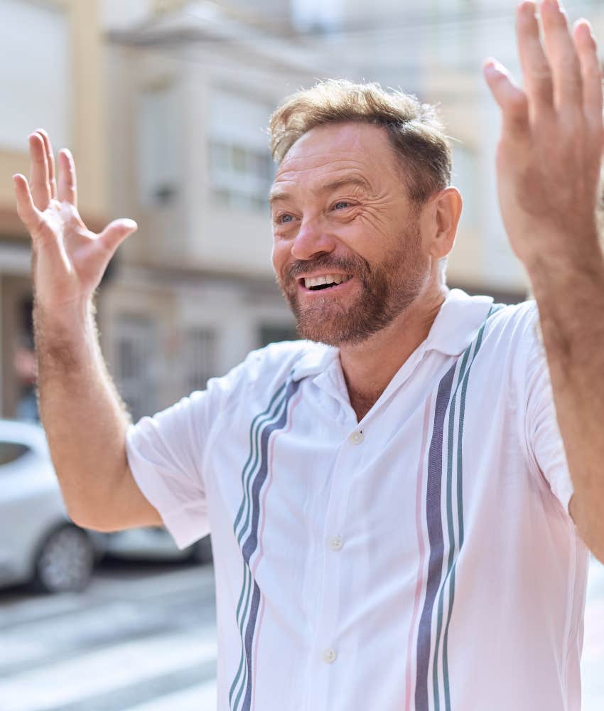secure person throws hands in the air and does not care