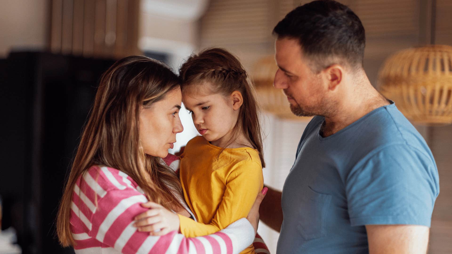 caring parents teaching daughter to trust her instincts in serious talk