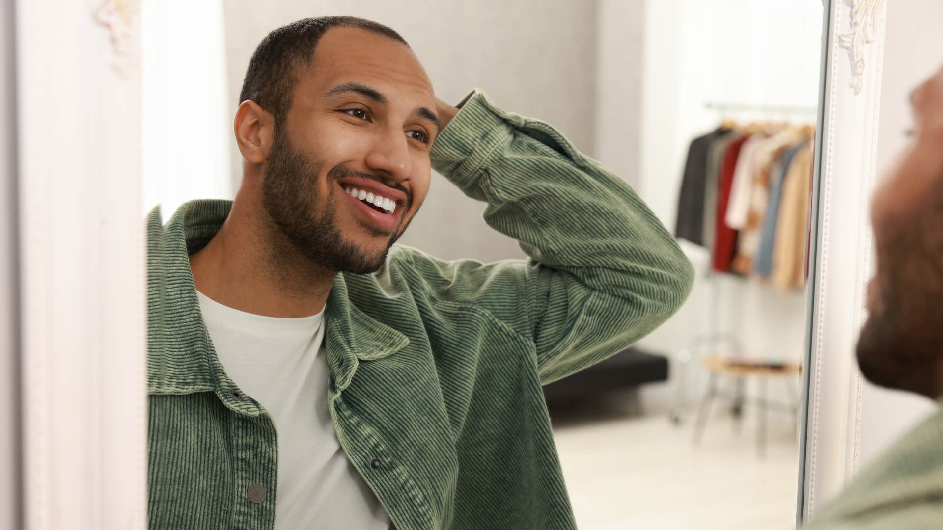 man being kind to himself practicing positive self-talk in mirror