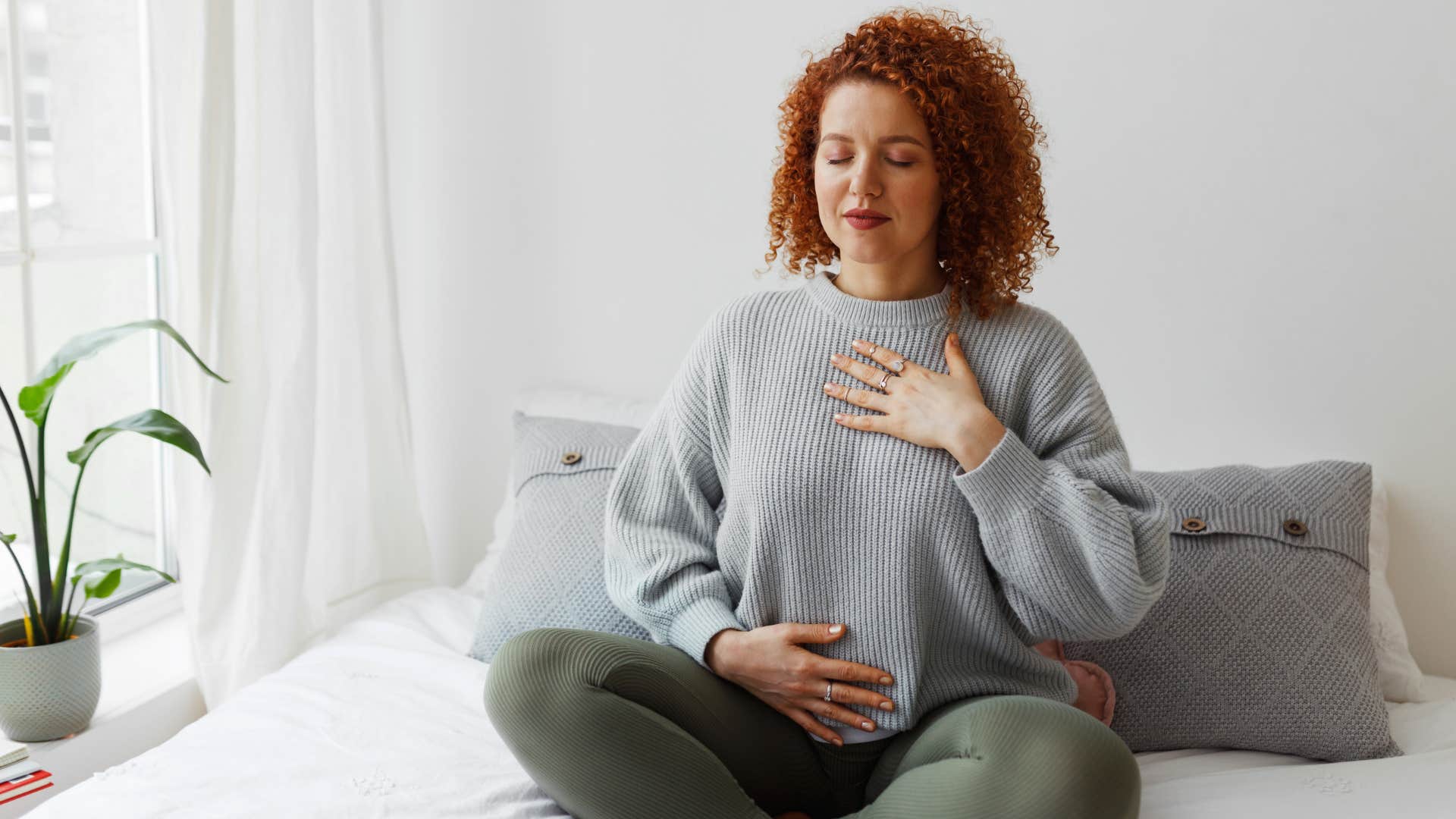 woman practicing her spirituality meditating in bed