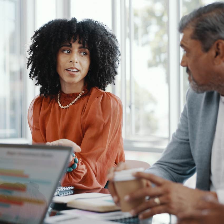 frustrated employee sitting in work meeting with colleague
