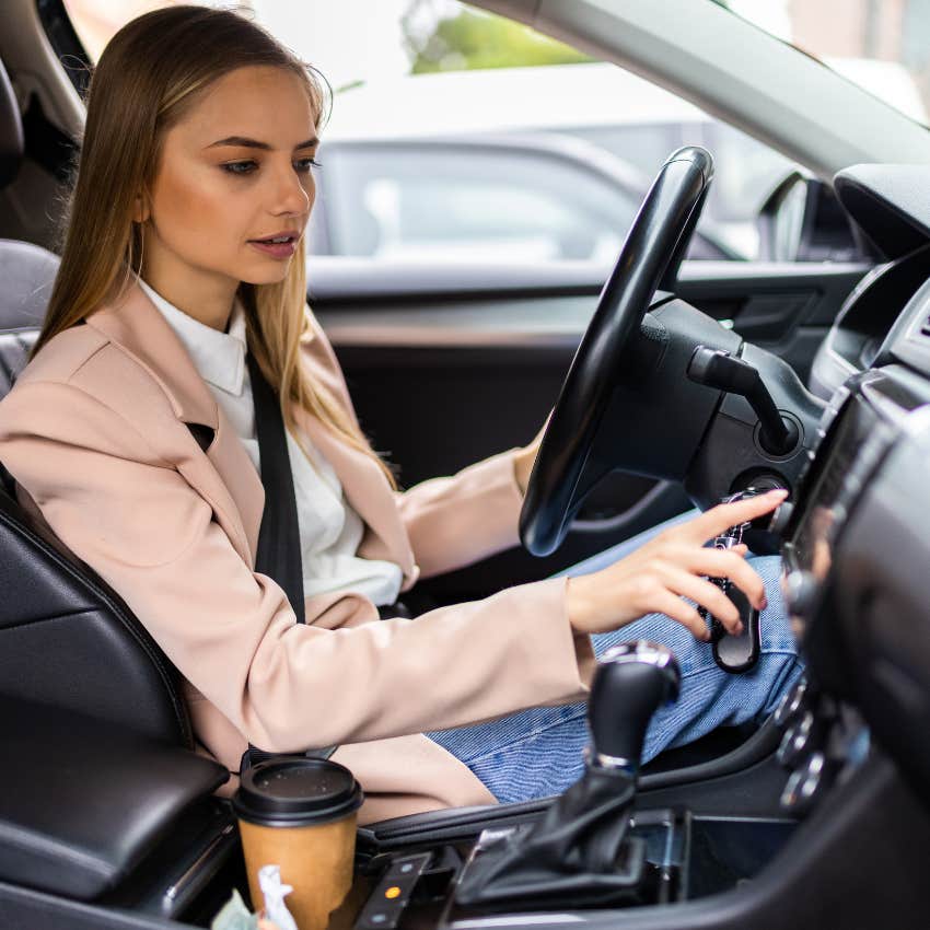 woman changing radio in car because today's music is so bad