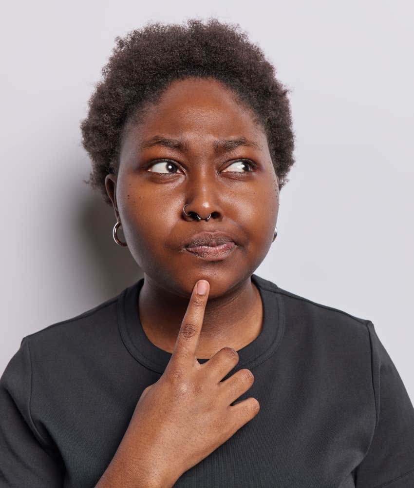 inquisitive person puts finger to chin showing curiosity drives them