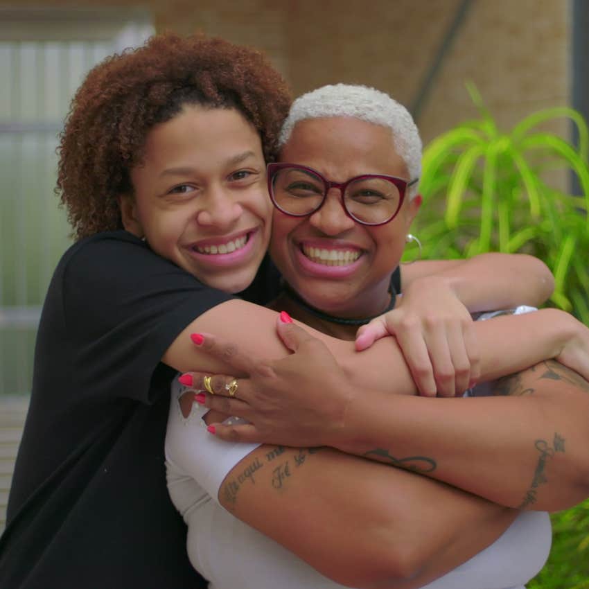 smiling teen son hugging mom