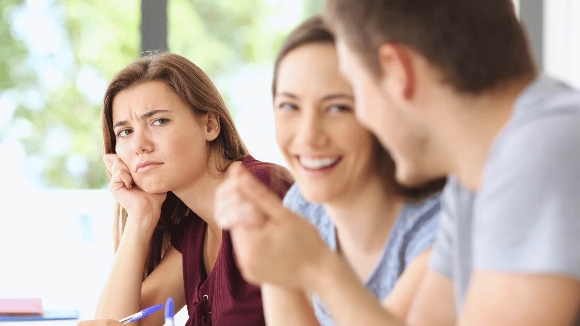 woman looking at happy couple feeling jealous