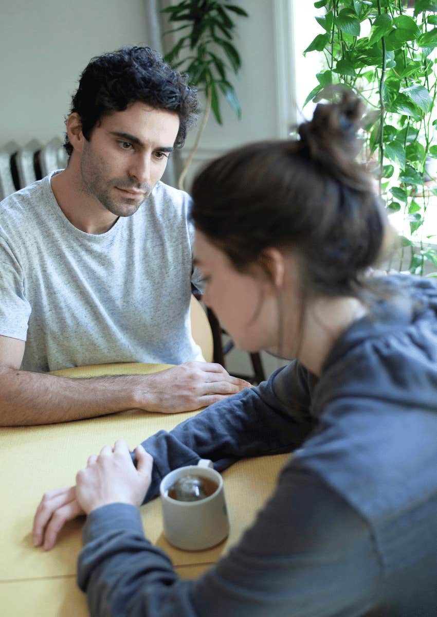 serious couple talking at dining table