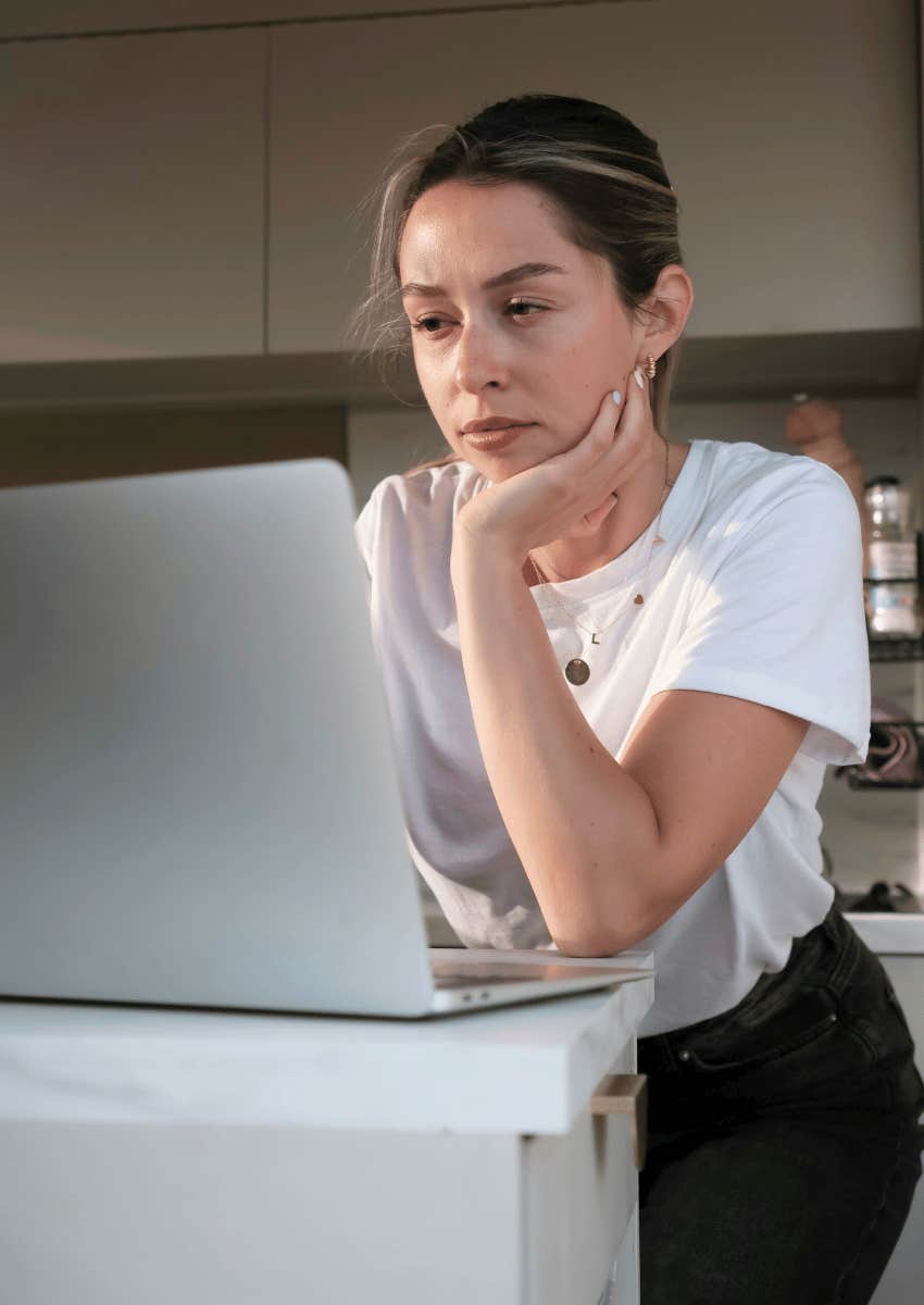 serious woman focused on her open laptop