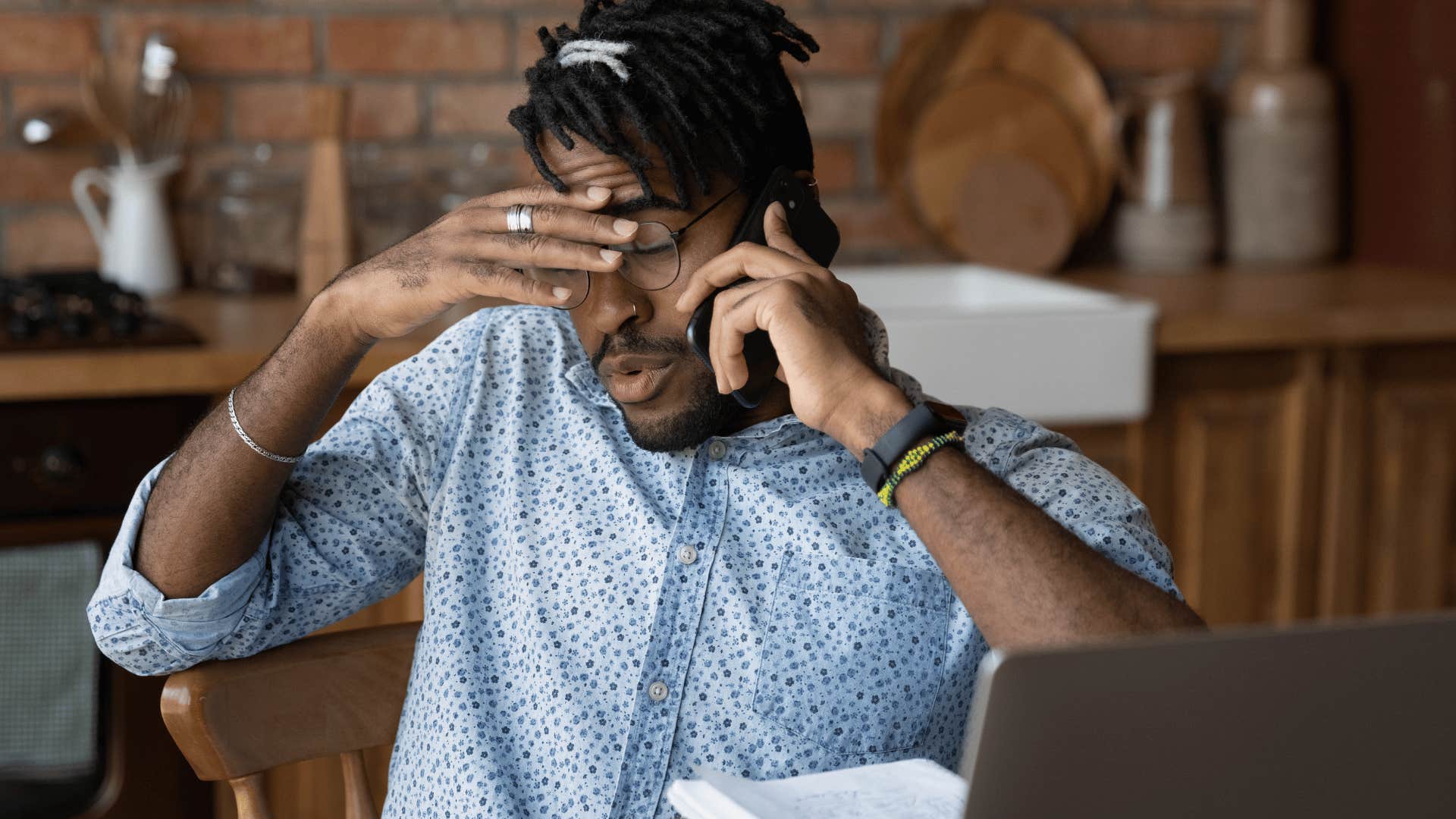Man who needs a break looks stressed in front of a computer at home