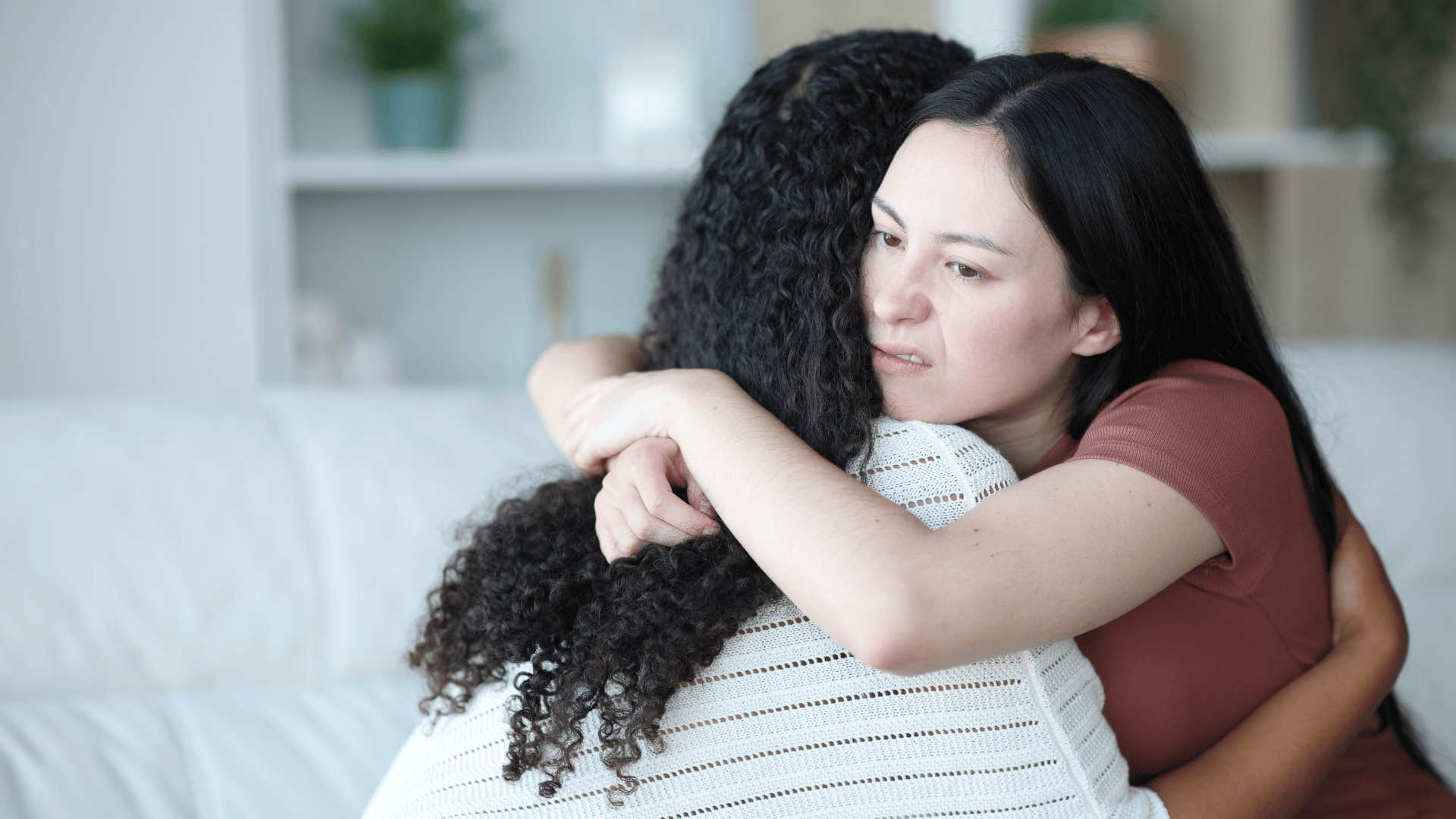 fake woman hugging friend giving her backhanded comfort