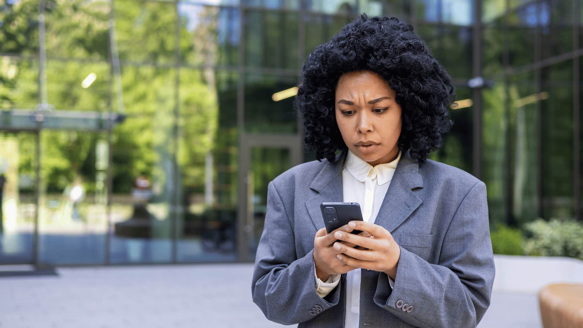 sad woman looking at mean text from her toxic mom