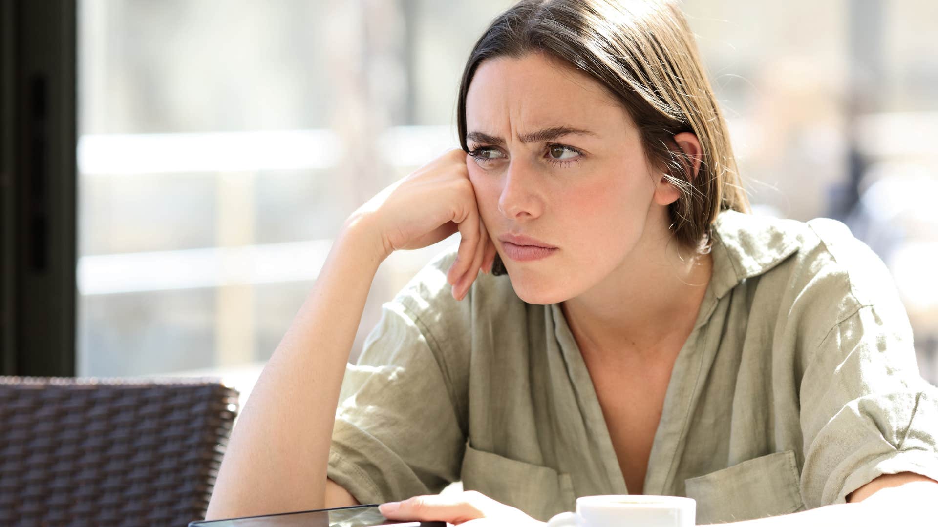 woman who's always pessimistic sitting alone outside