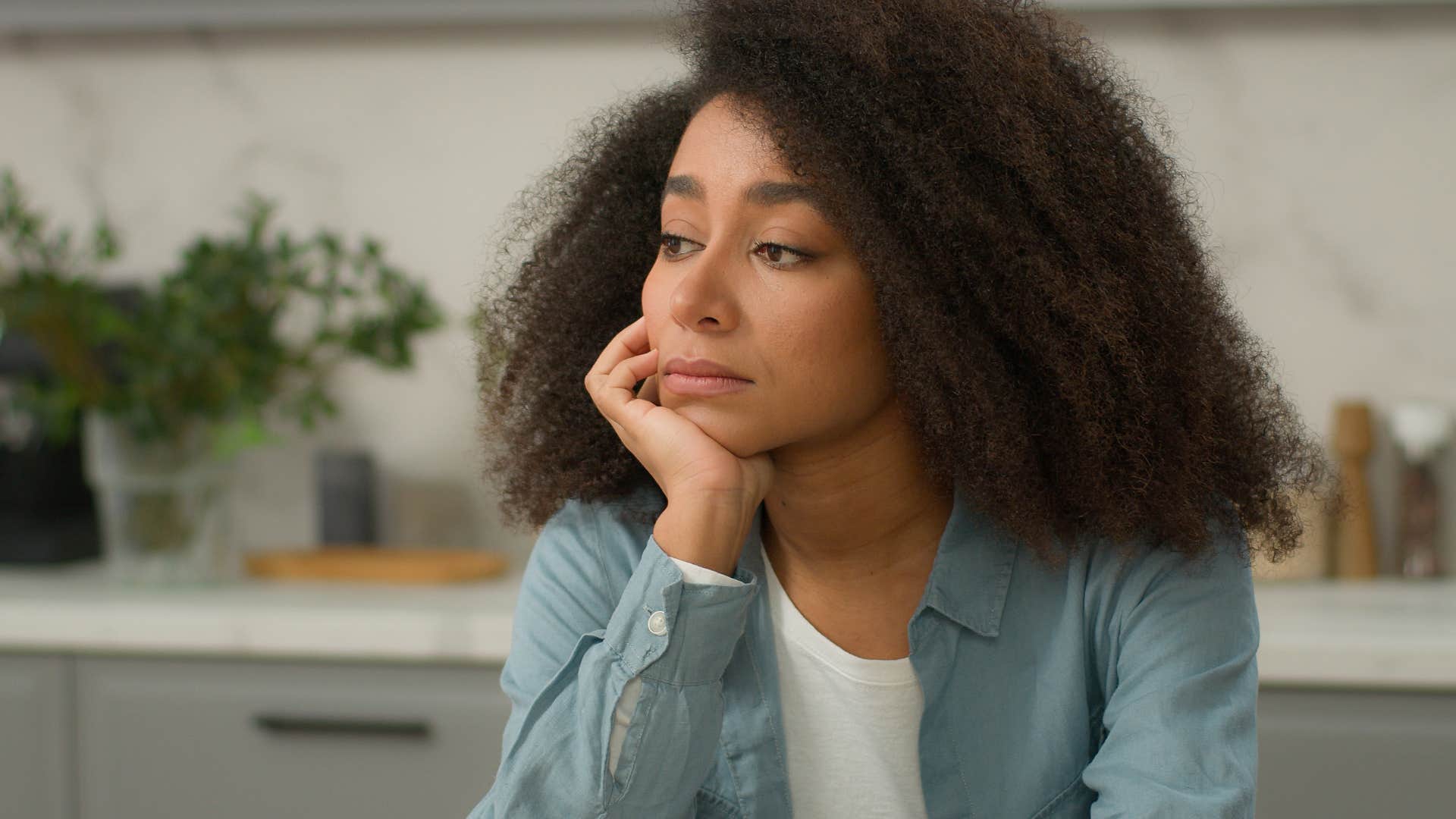 pensive woman struggling to sit in silence at home