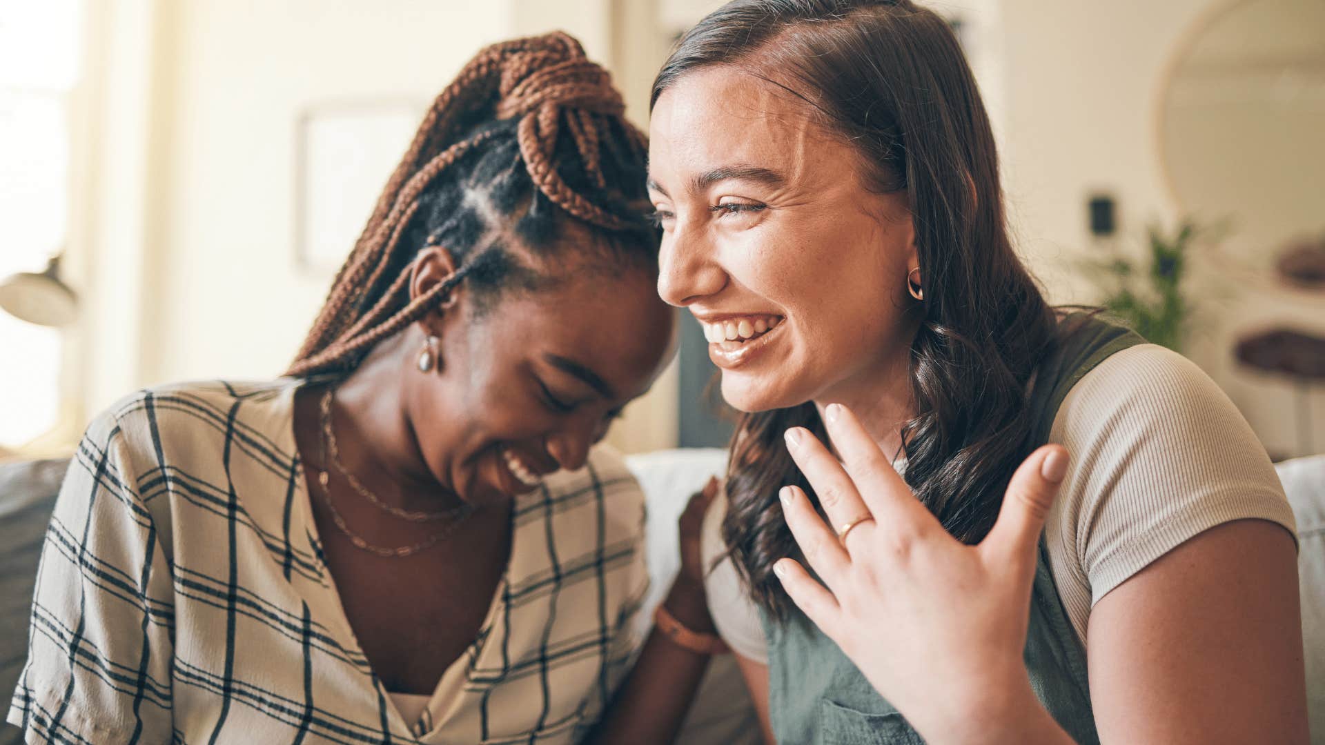 two friends talking and gossiping laughing