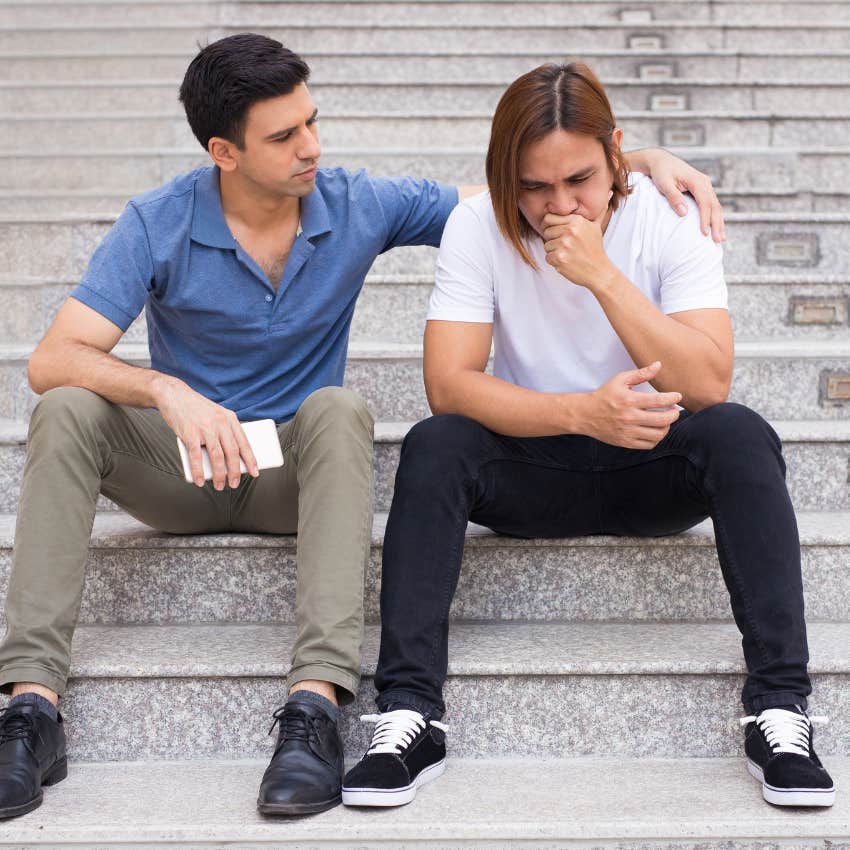 Two men who are best friends forever talking seriously on some steps 