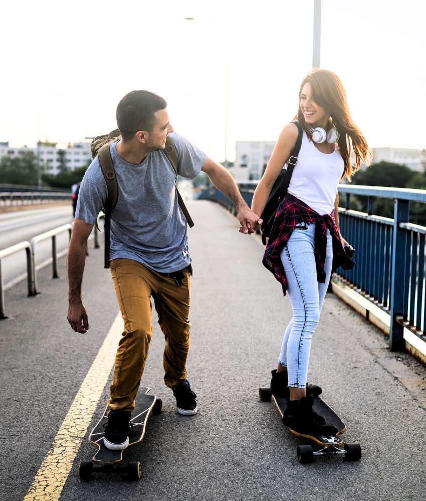 happy couple on skateboards showing they can take risks
