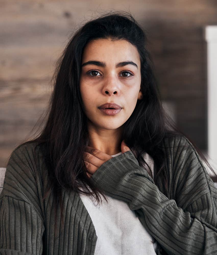 aware person places hand on chest to calm stress