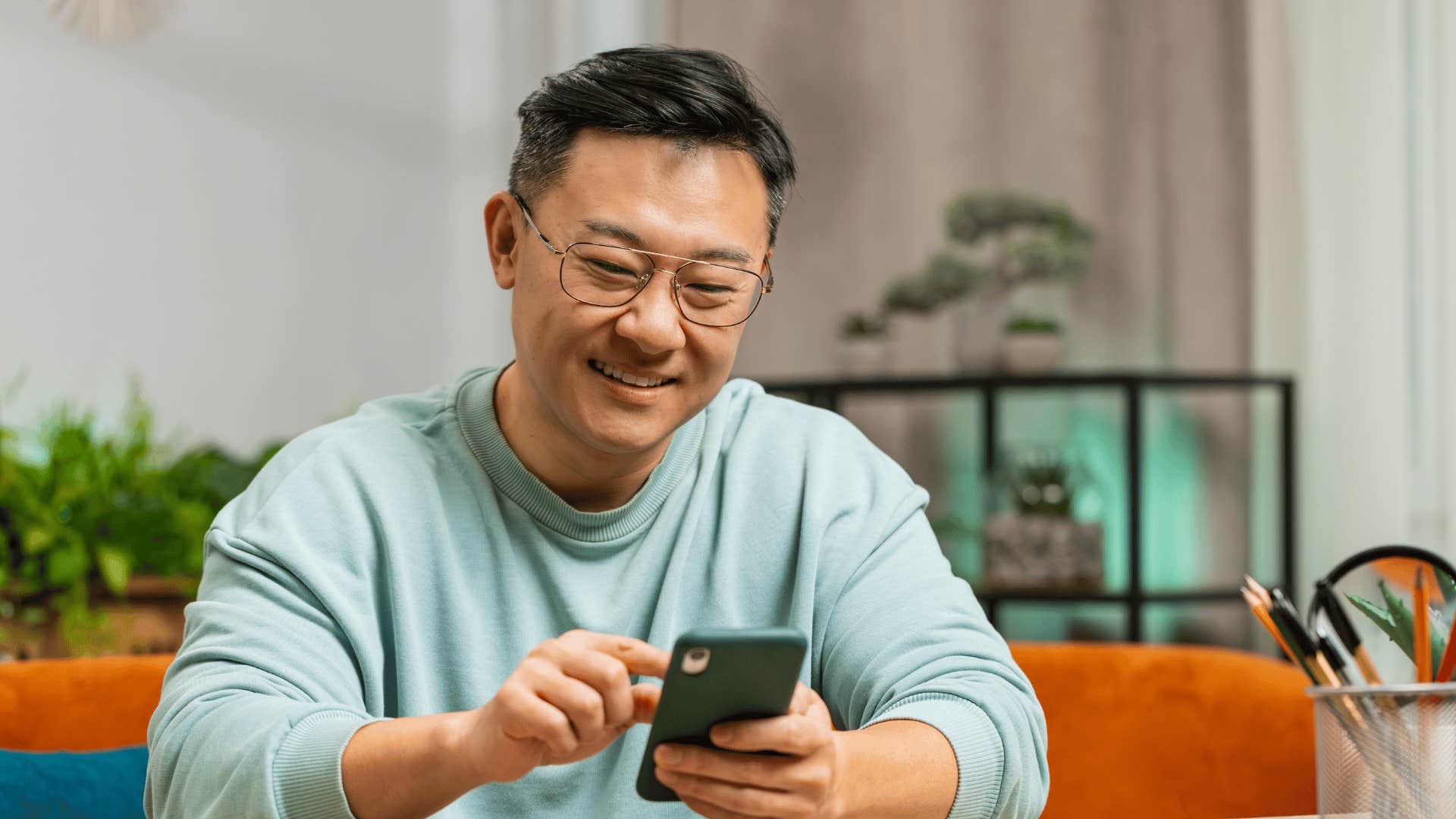 man looking at subscriptions on his phone that he forgot about