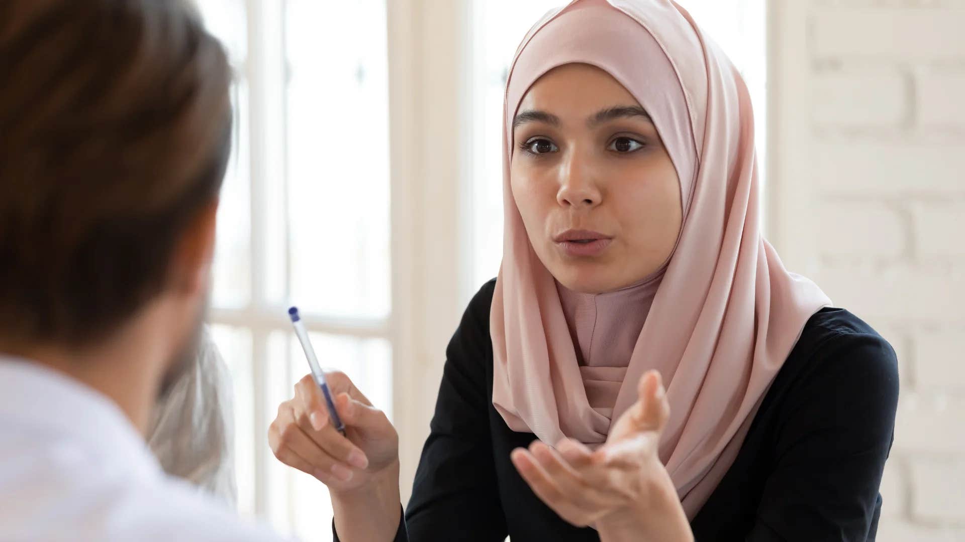 smart woman explaining to colleague why saying i don't care is offensive