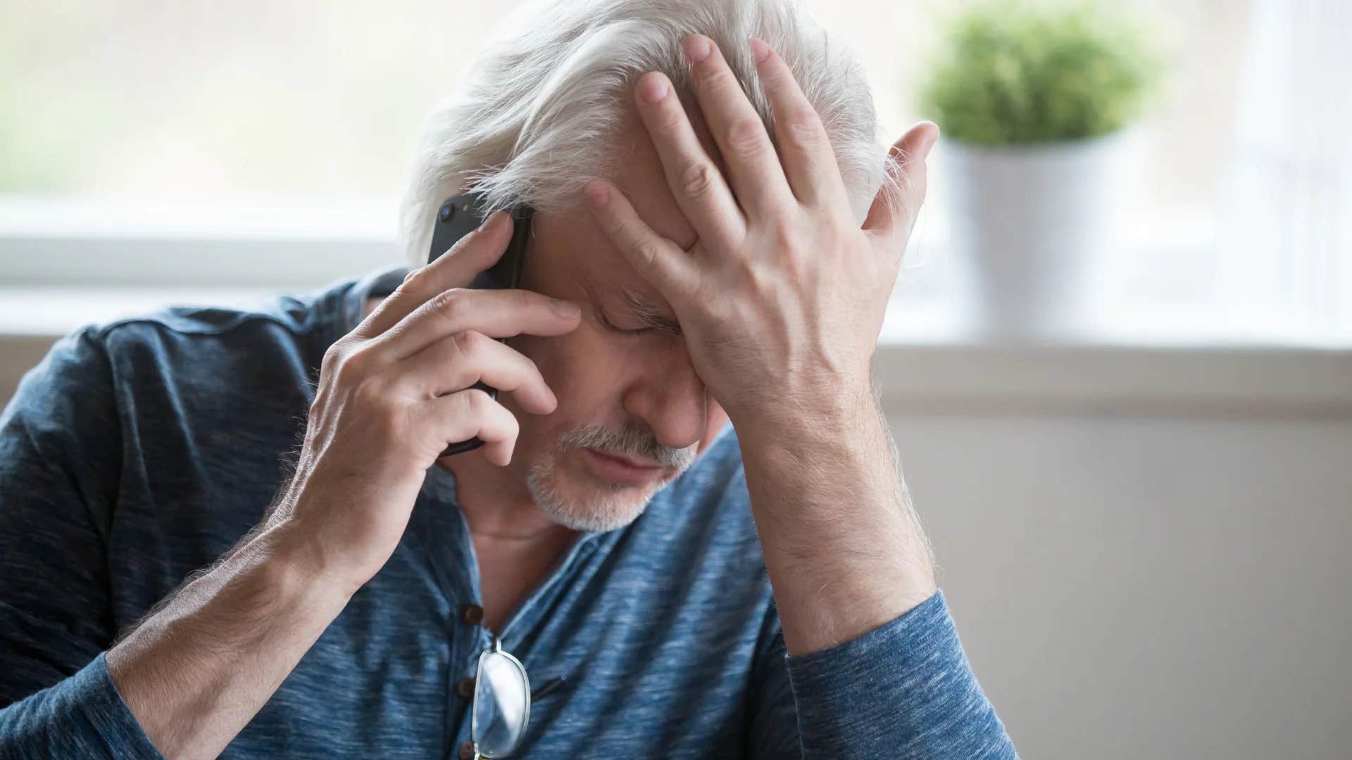 man on the phone listening to someone say nothing ever works out for me
