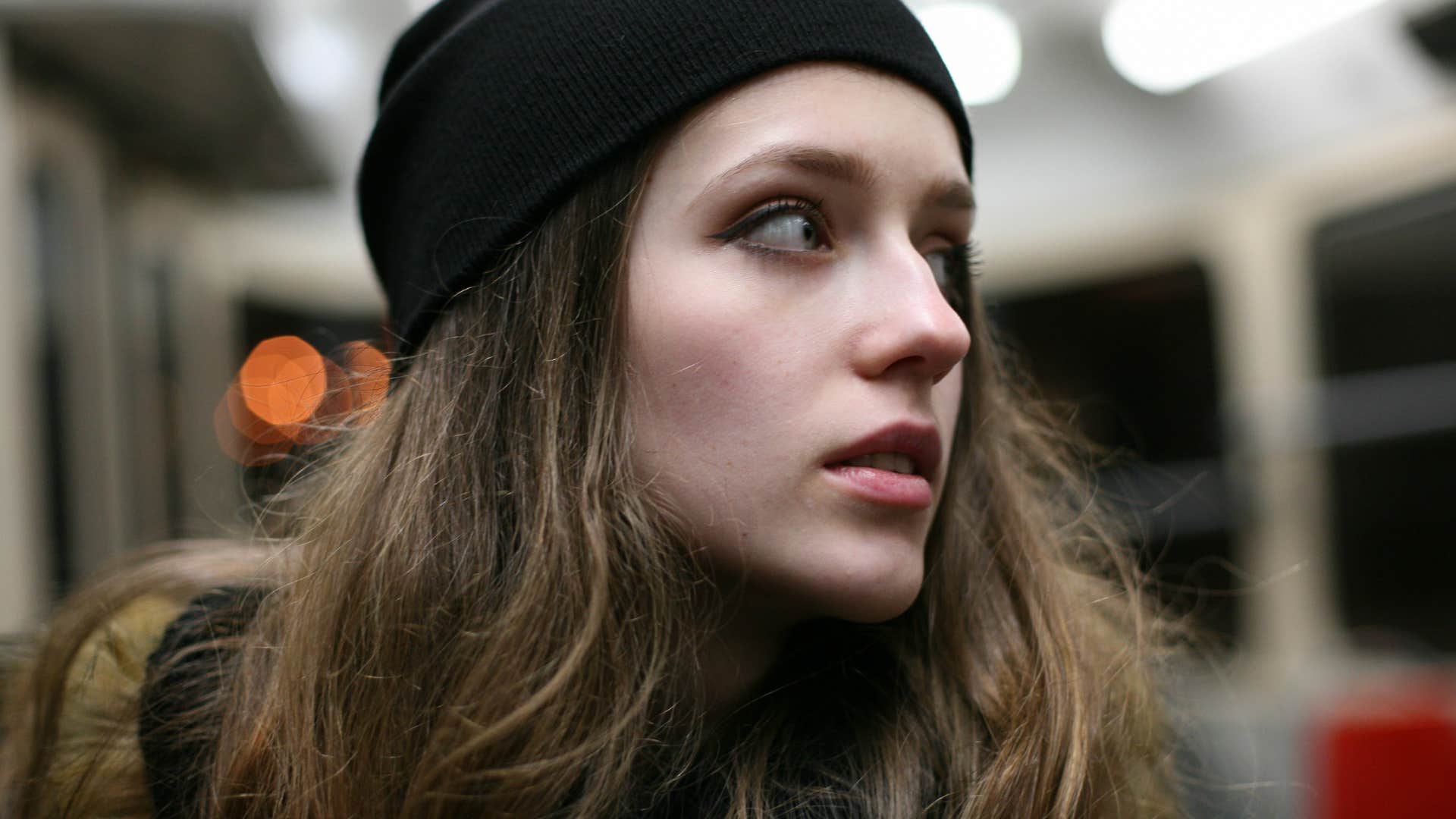paranoid woman avoiding strangers in public on the bus