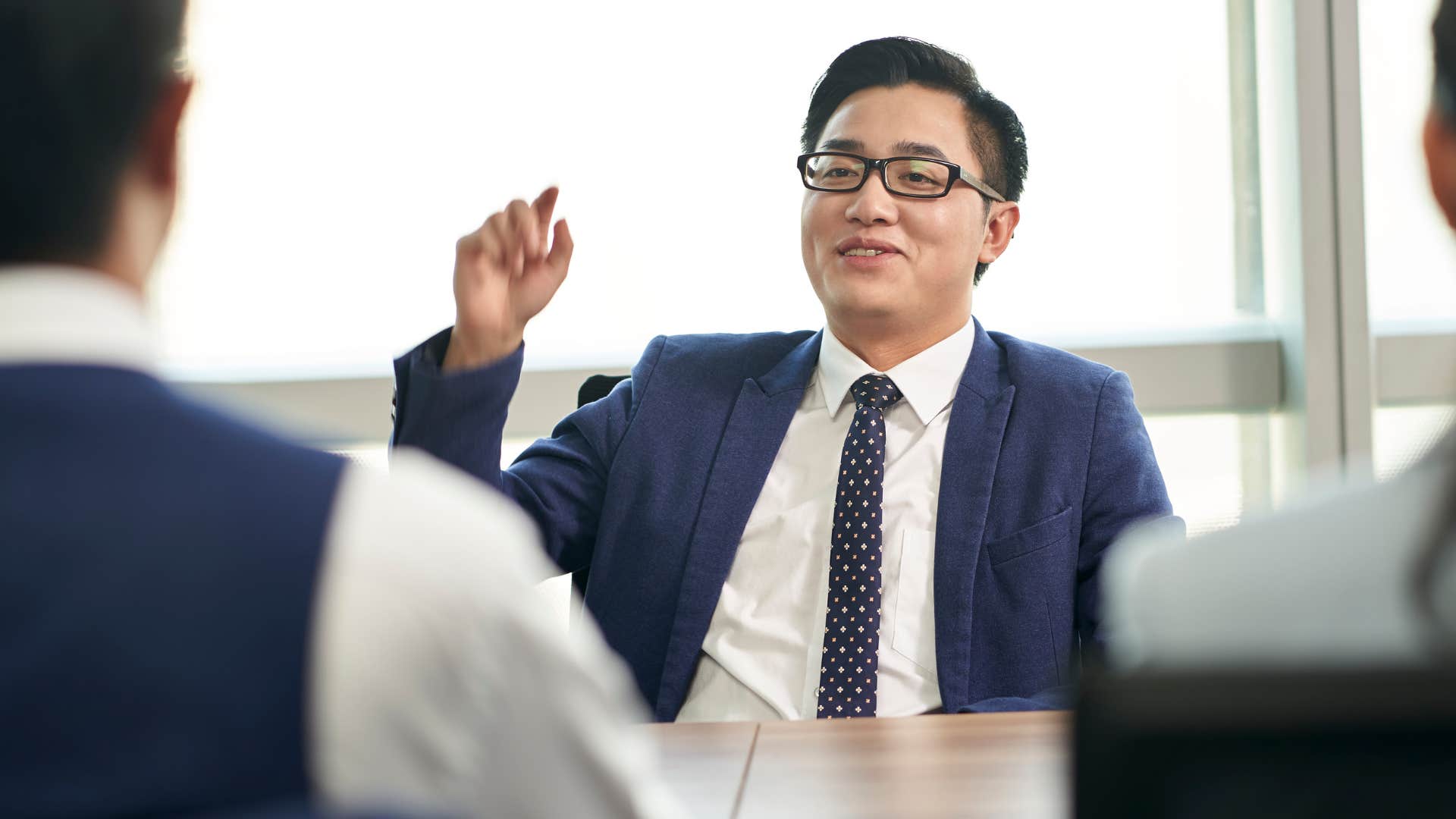 man showing off achievements at work in meeting