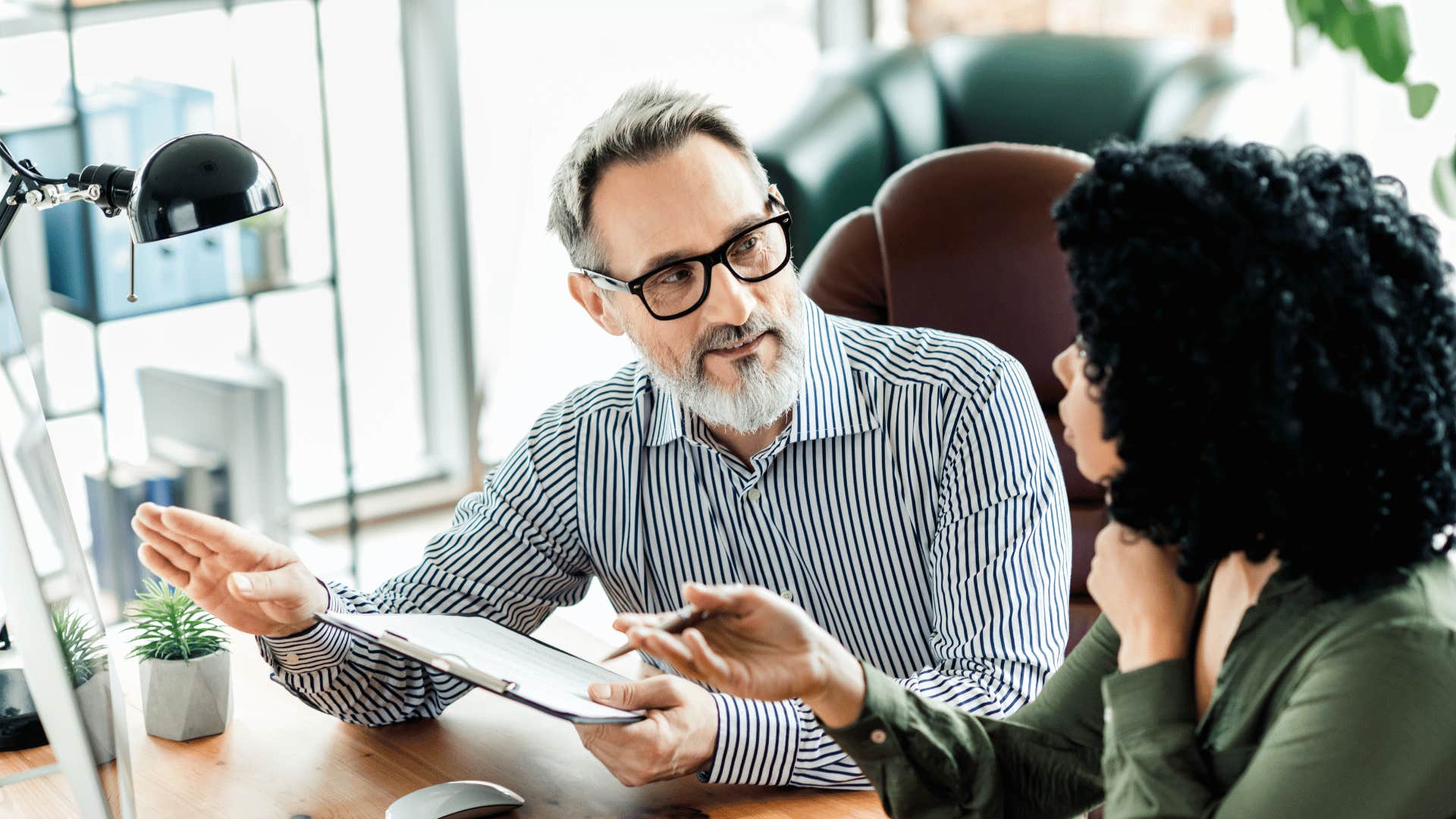 nervous man saying sorry that came out wrong to his coworker