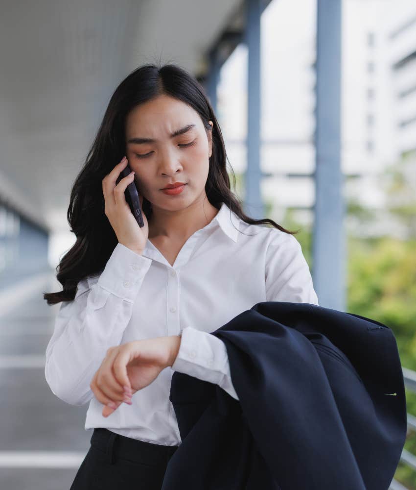 people pleaser talks on phone while walking and checks time