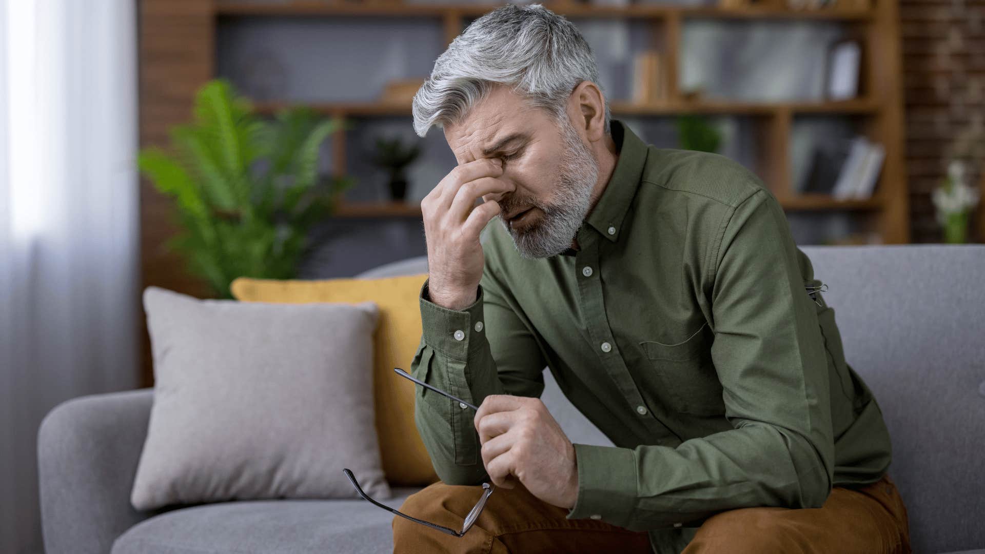 exhausted man struggling with his mental health at home
