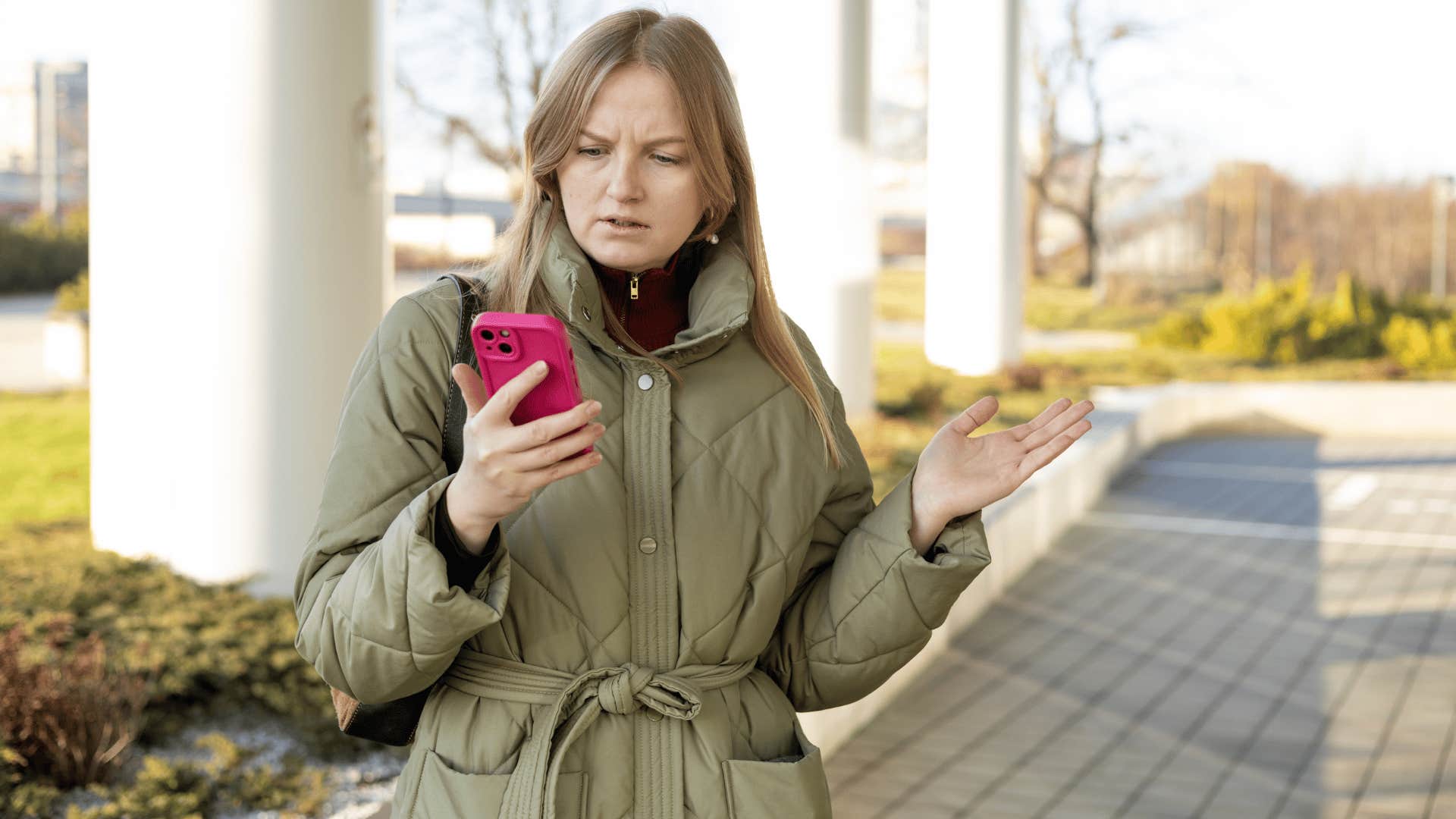 woman looking at phone annoyed someone is interrupting her alone time