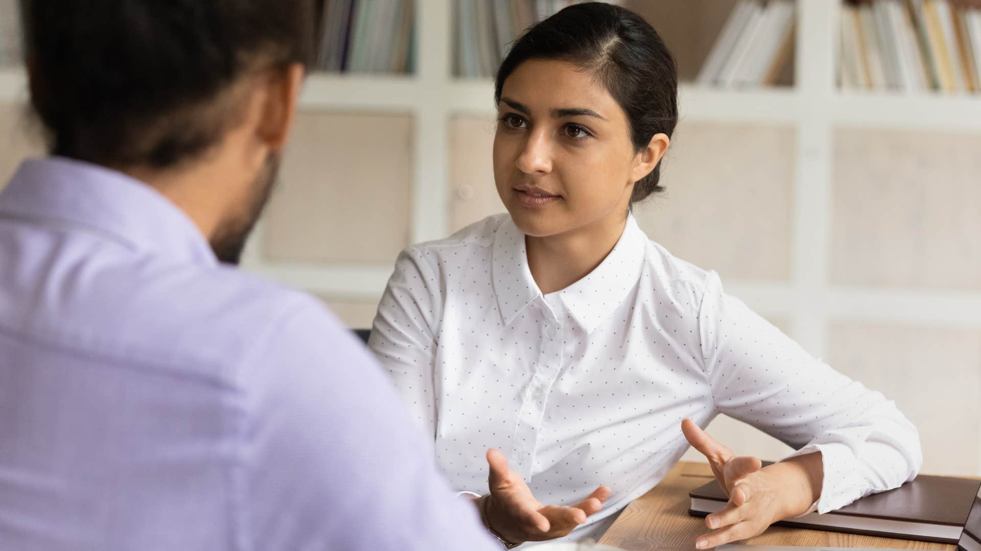 woman trying to humble her highly intelligent colleague by telling him it's not that complicated