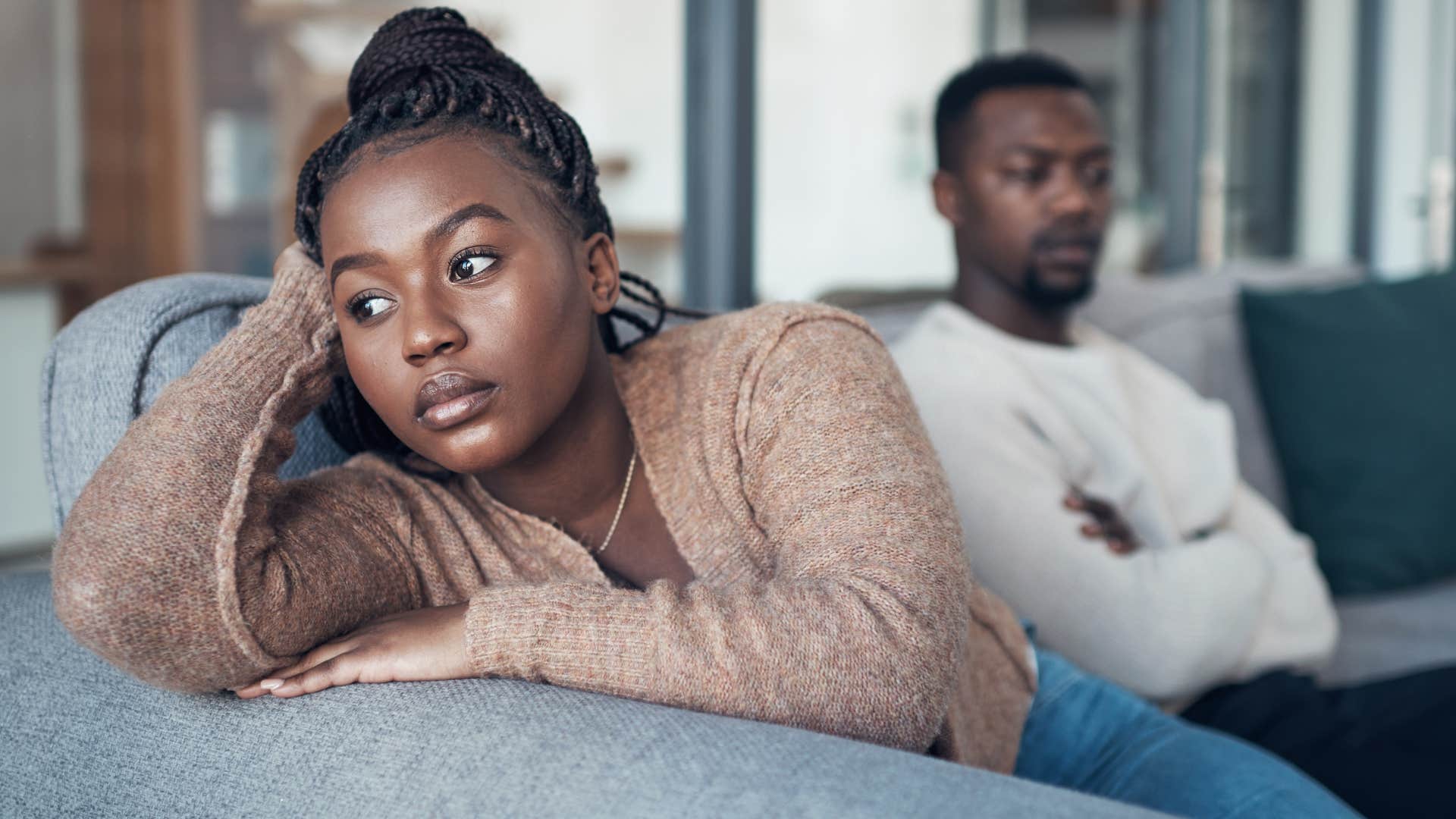 irritated wife turned away from husband after telling him it's not that big of a deal