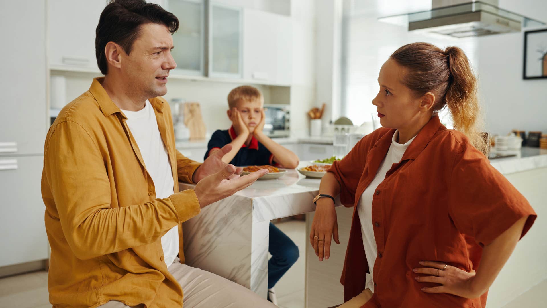 couple arguing in front of their child with wife saying see what you're doing to the kids