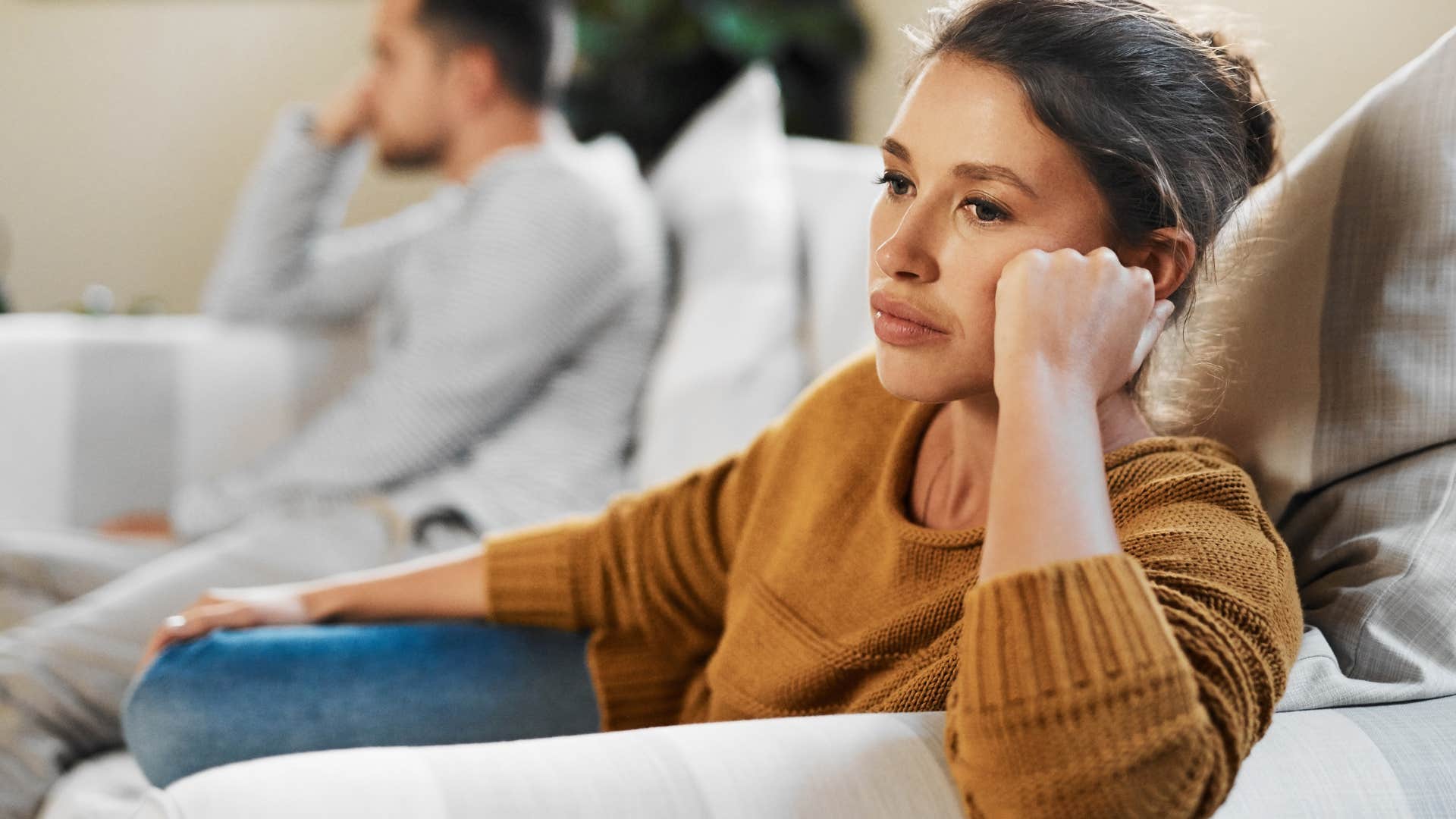 woman turned away from upset husband telling him why can't you be more like