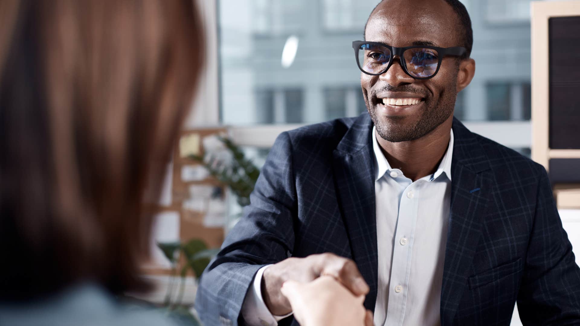 charismatic man leading with confidence shaking hands