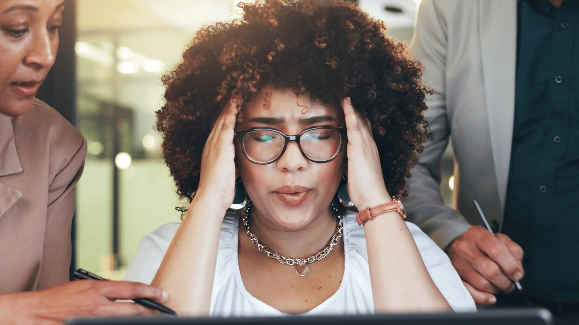 woman who's often underprepared at work looking stressed