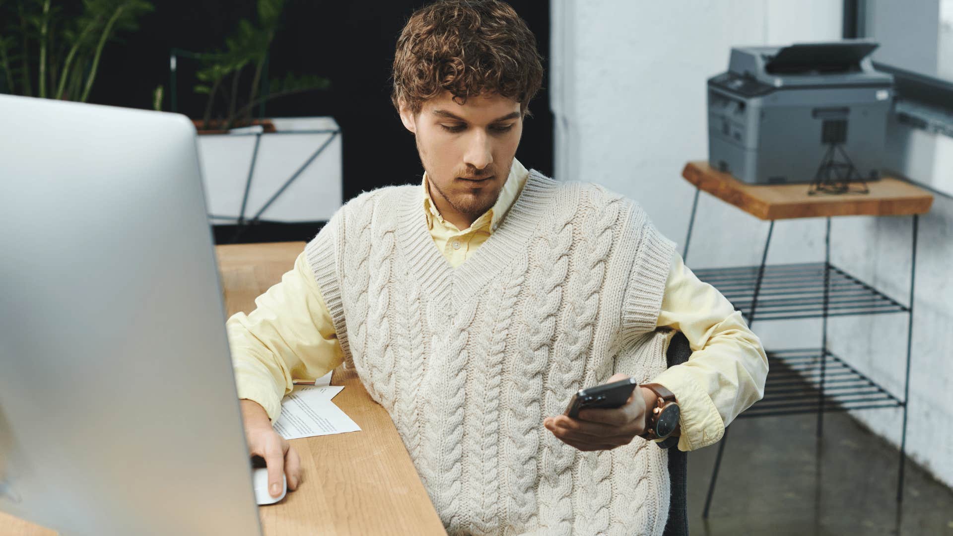 fake intellectual man picking up his phone constantly at work