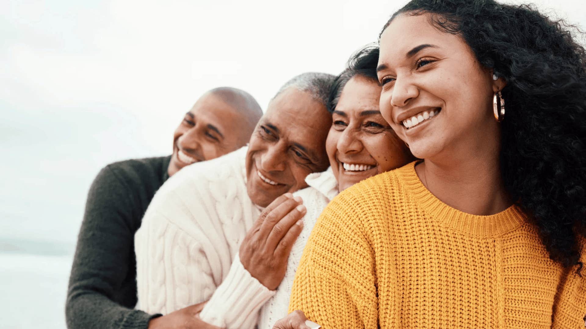 parents and adult children forming line of hugging