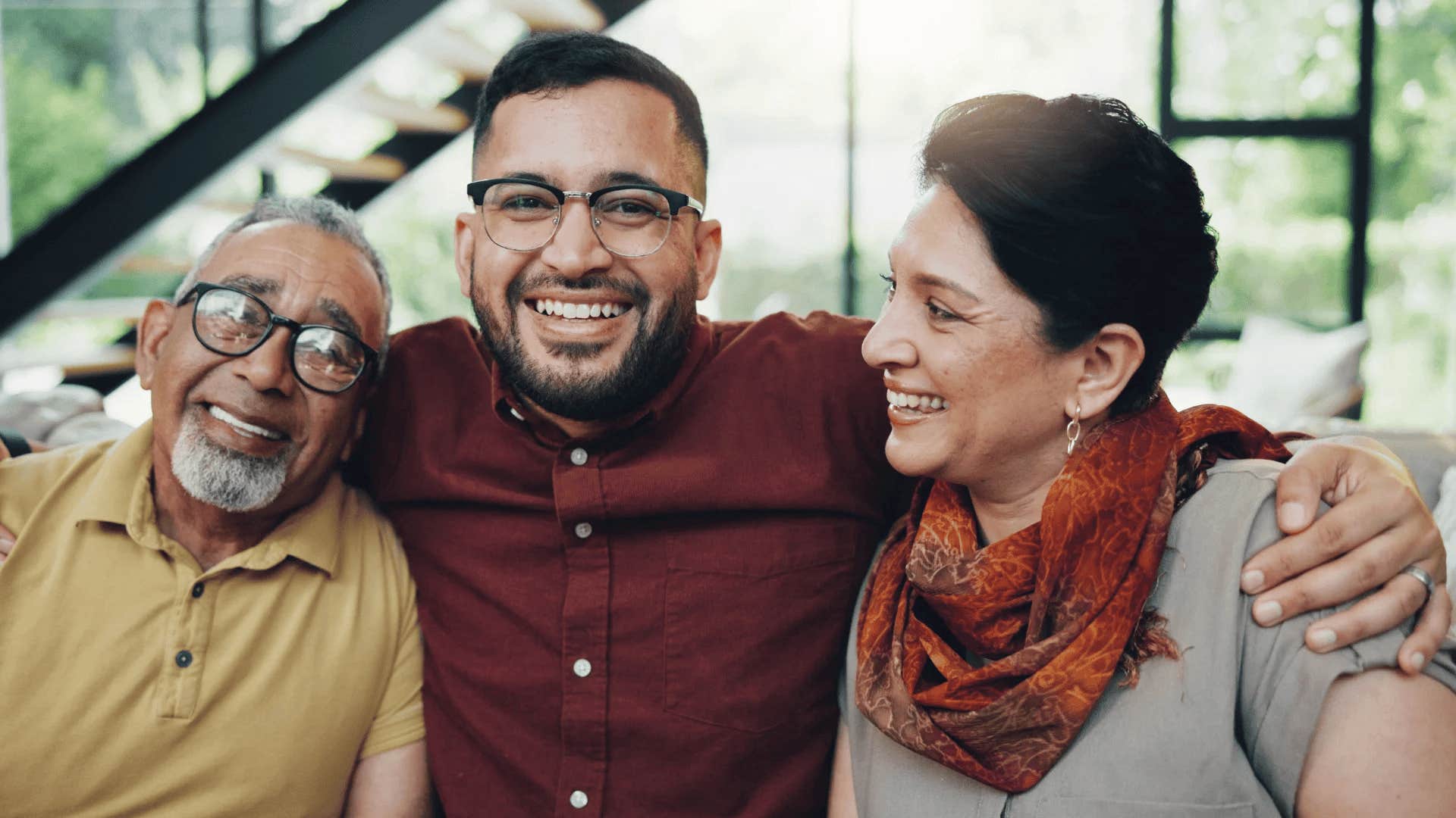 man hugging his parents who taught him to be married by his 30s