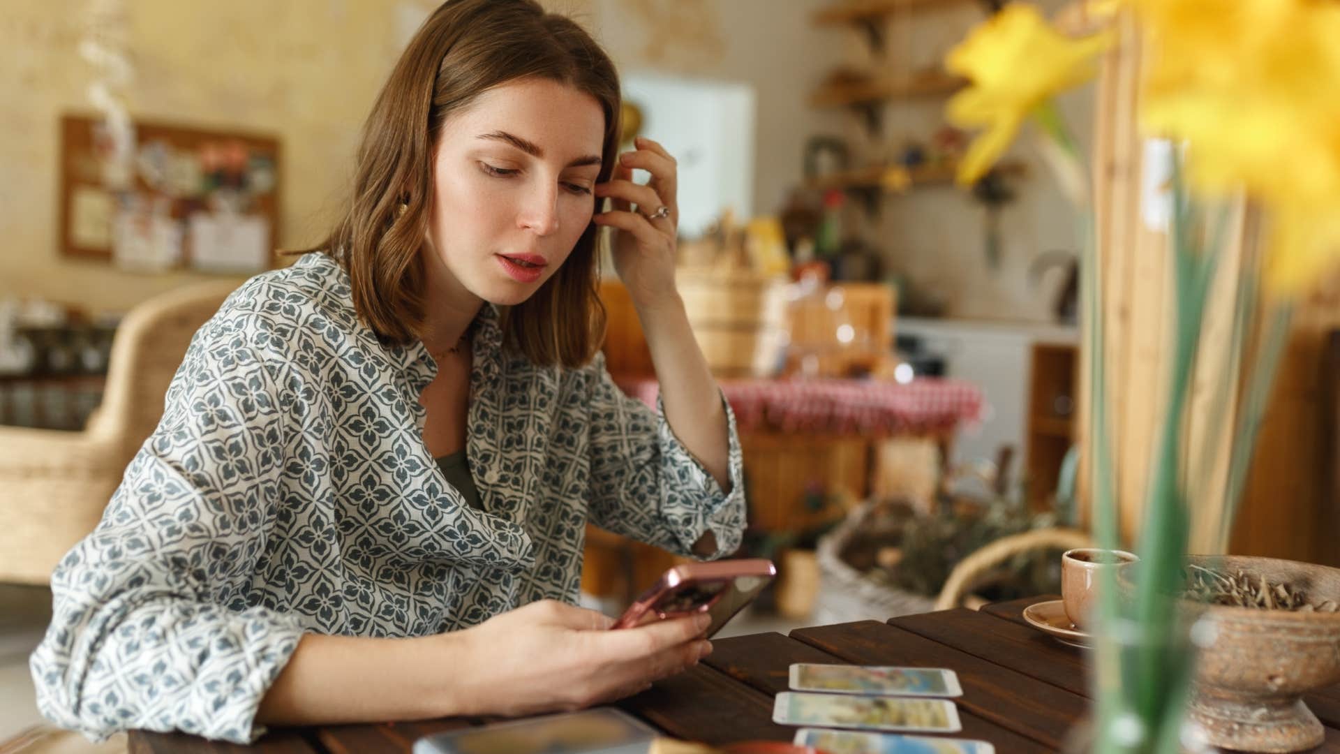 woman practicing spiritual rituals reading tarot cards to control her energy