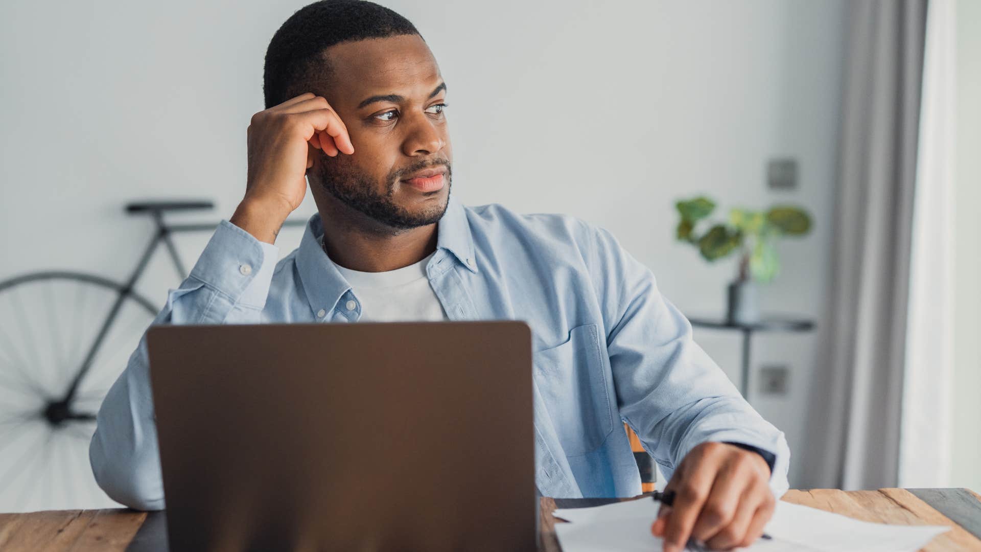 man on his laptop releasing limiting beliefs to manifest a reality he wants