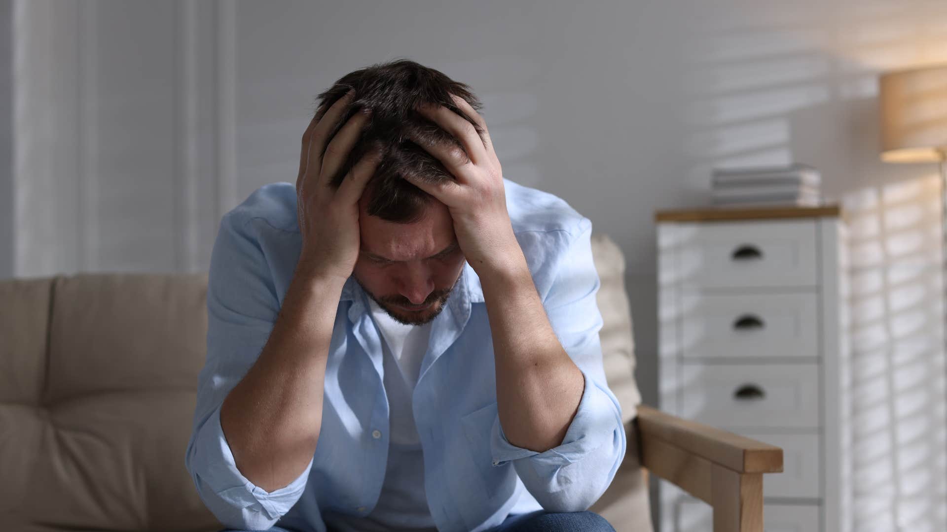 stressed man clutching head saying everything's kind of a mess right now