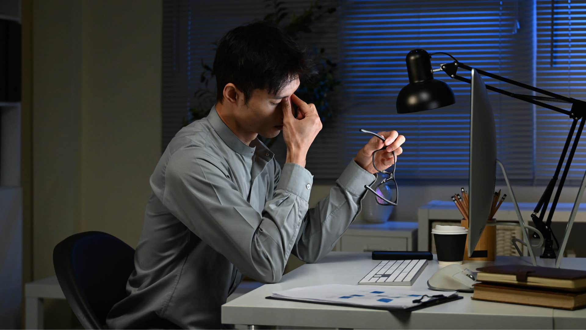 tired man working late saying i didn't sleep much