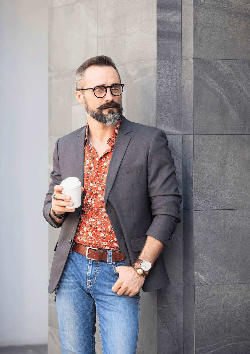 stylish mature man holding a small cup of coffee