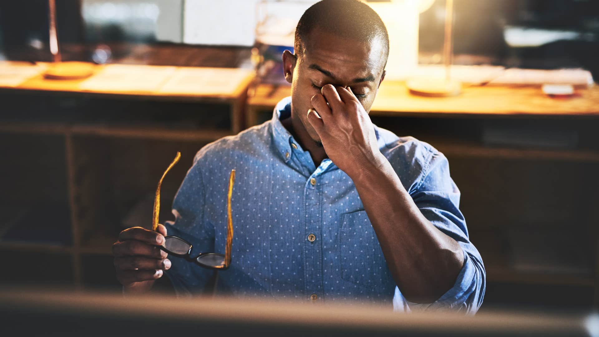 Man who's never taking a vacation working late in an office.