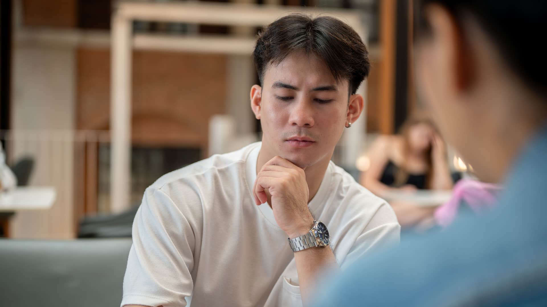 concerned man standing up for others in tense conversation