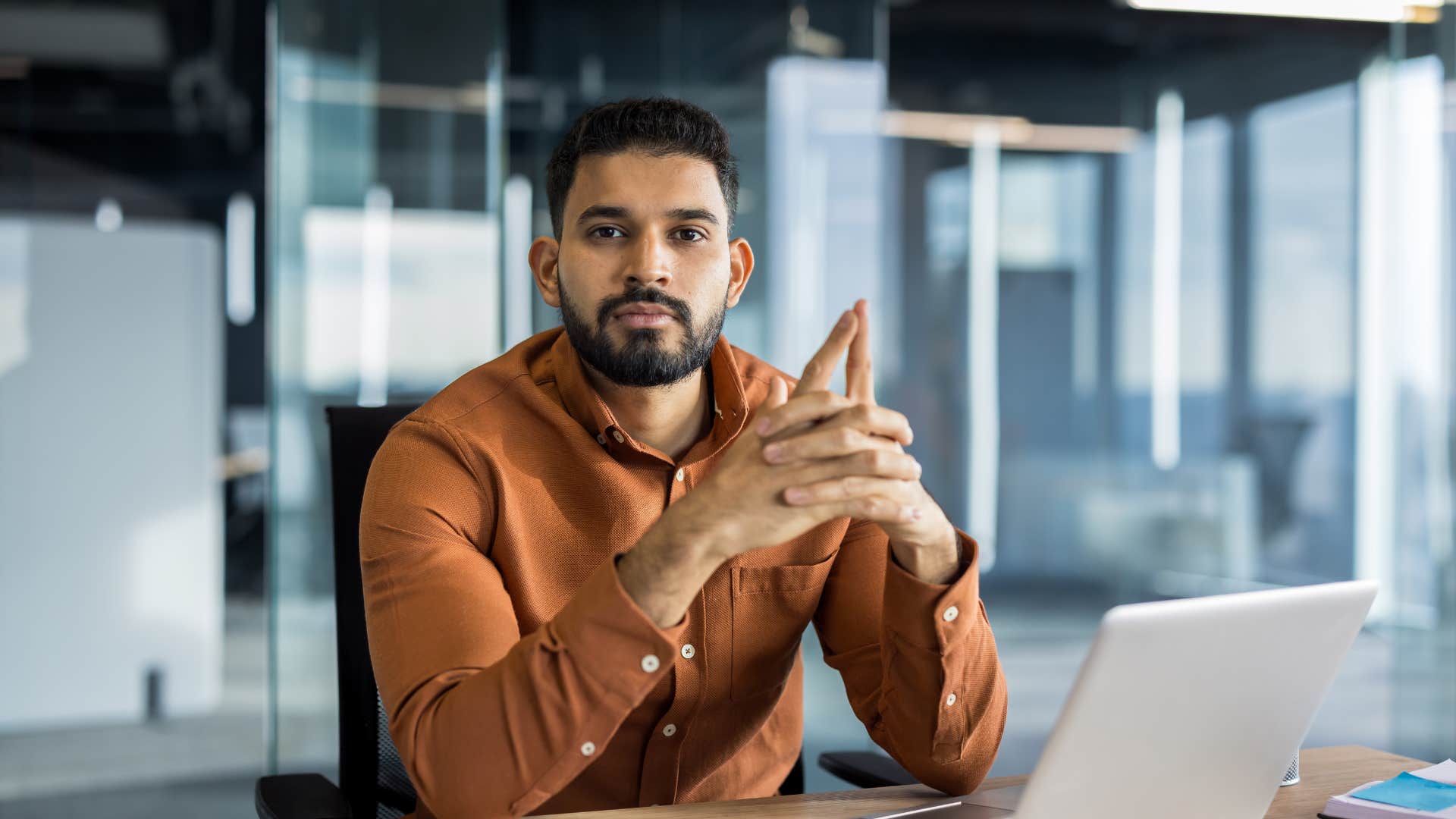 man trying to look busy at work twiddling his fingers