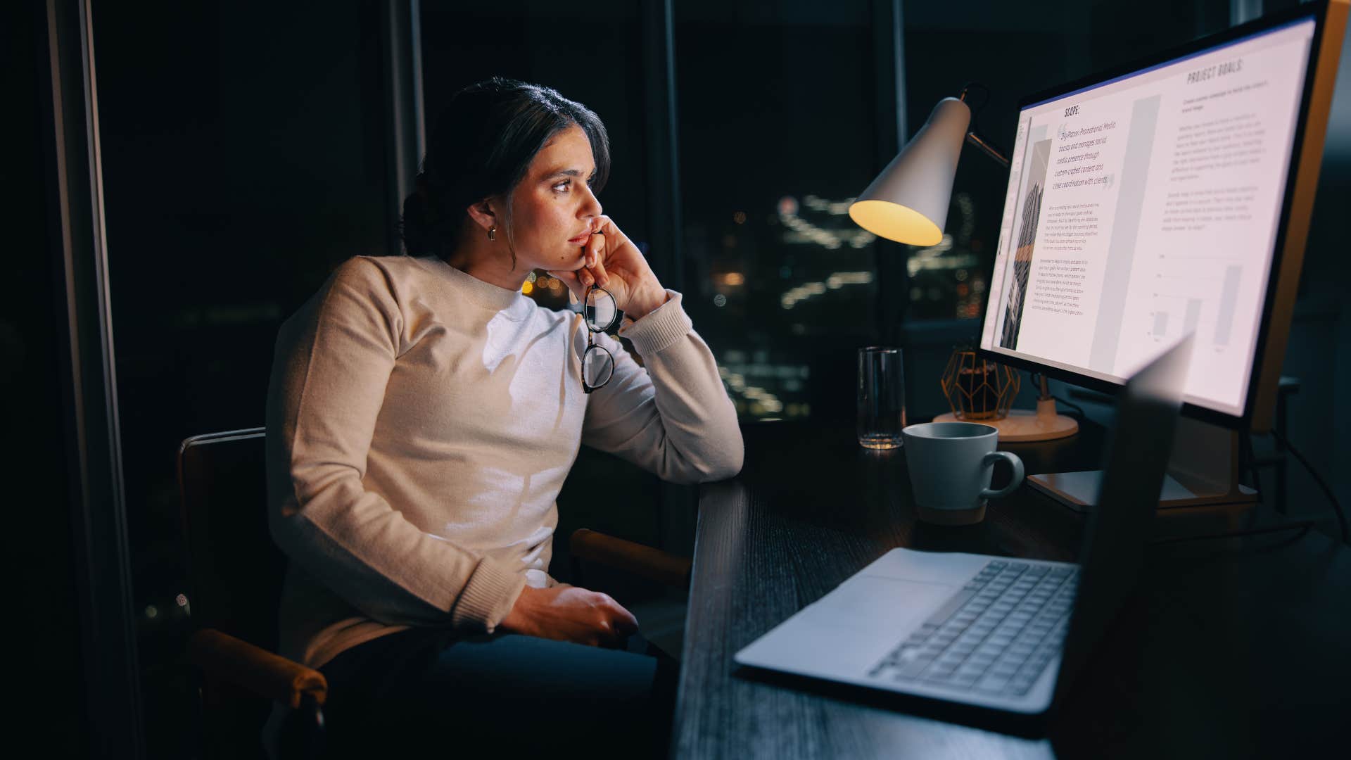 tired employee working at desk after hours