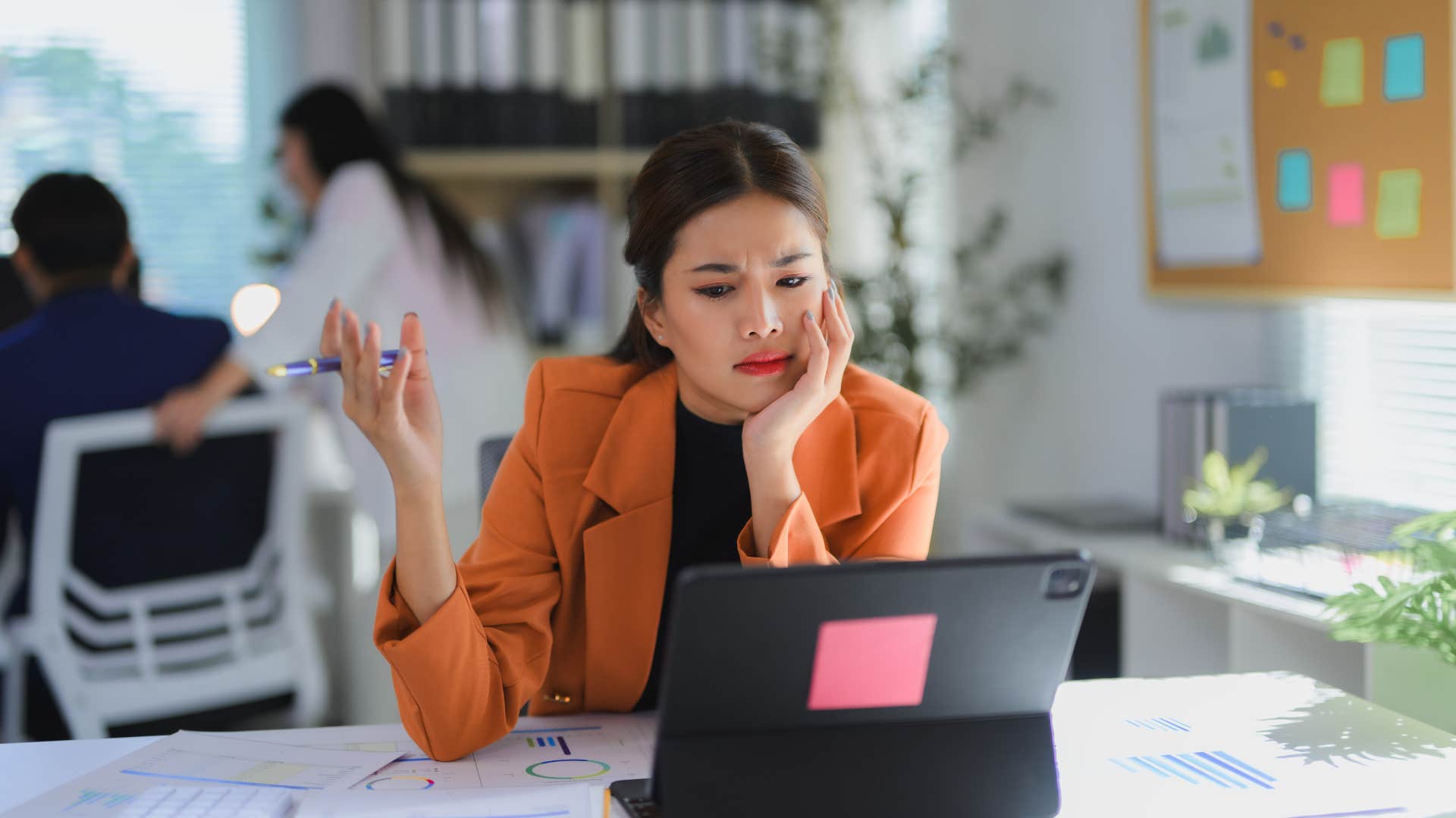 frustrated employee sitting at desk refusing to accept company loyalty